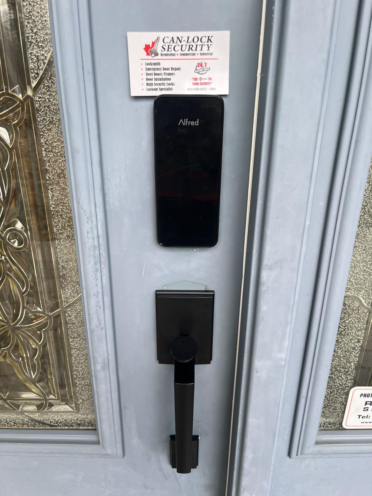 Alfred smart lock keypad installed on an exterior door with a Can-Lock Security business card