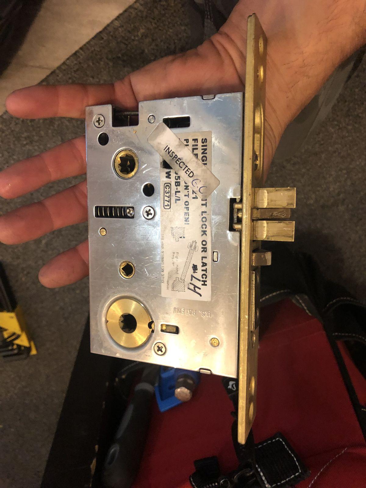 Mortise lock mechanism removed for service and repair