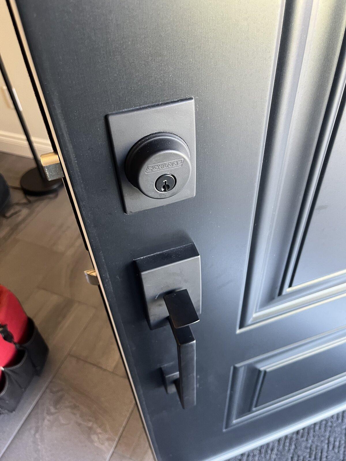Residential entry door before keypad smart deadbolt installation in Ottawa
