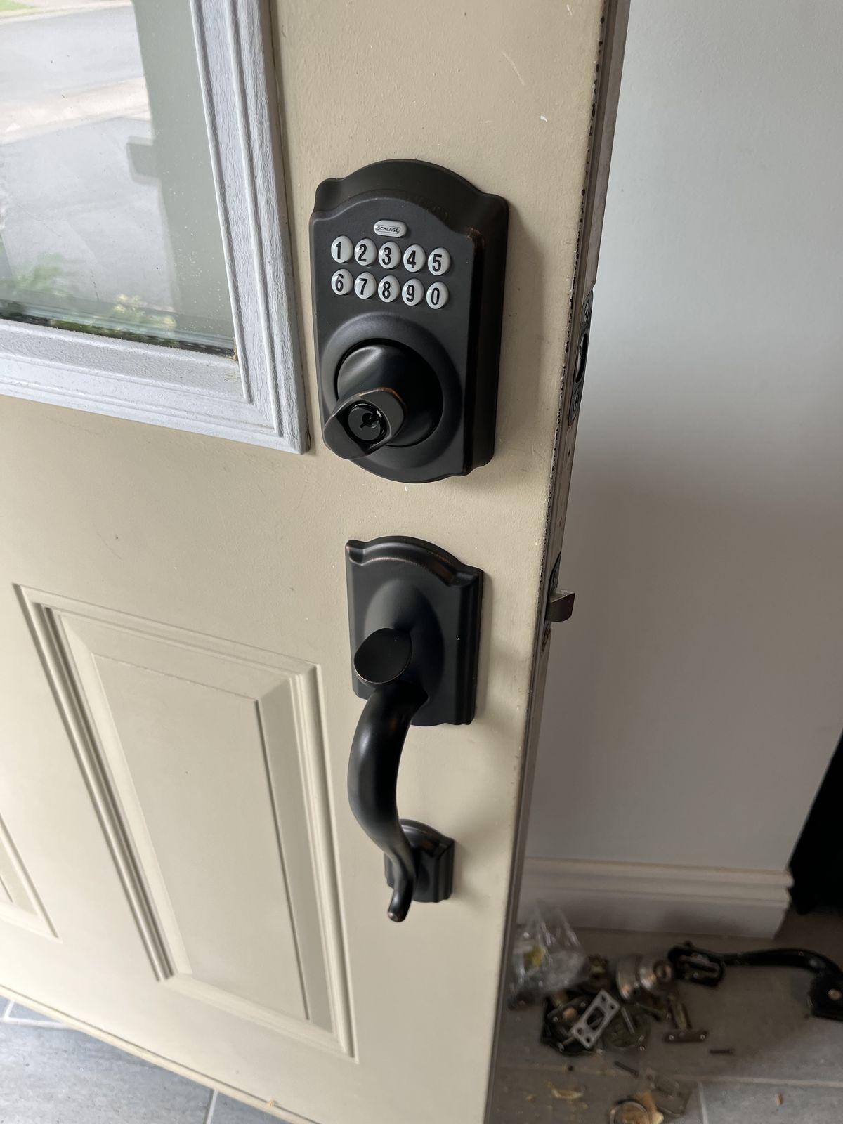 Schlage keypad deadbolt and matching handleset installed on a residential entry door