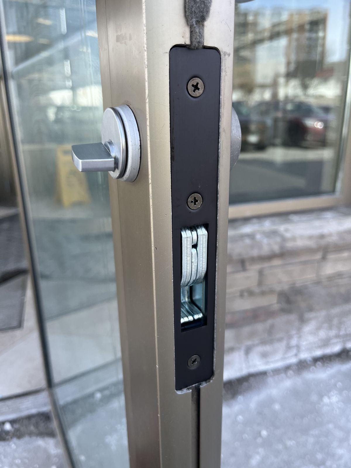 Commercial storefront door lock and thumbturn on an aluminum glass entry
